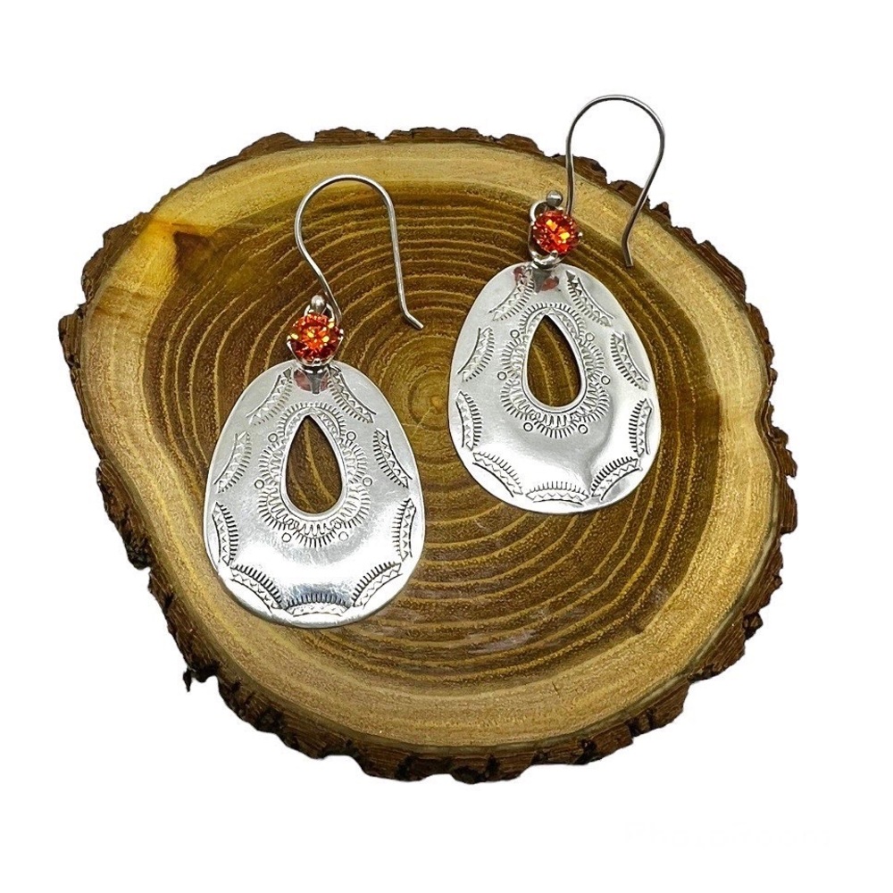 Sterling silver earrings with a bright sparkly orange gem